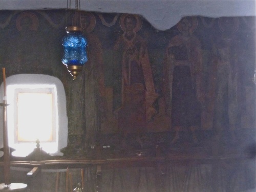 South wall frescoes of saints through a north side window